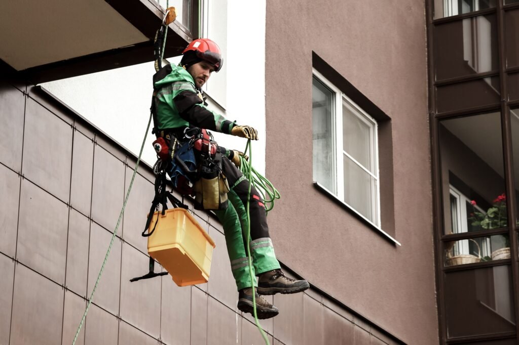 Industrial mountaineering worker during high rise work